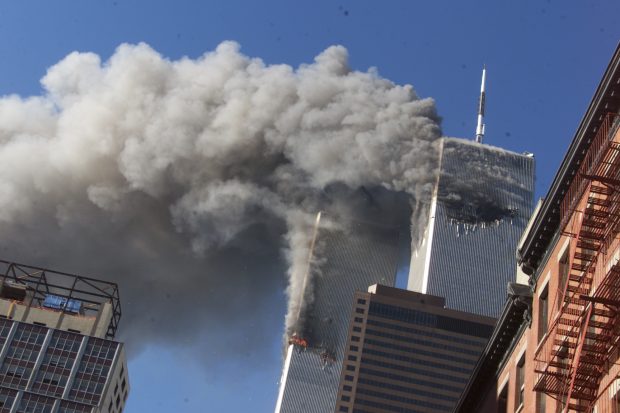 Smoke rises from the burning twin towers of the World Trade Center after hijacked planes crashed into the towers on September 11, 2001 in New York City.(AP Photo/Richard Drew)