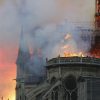 Smoke billows as flames destroy the roof of the landmark Notre-Dame Cathedral in central Paris on April 15, 2019. - A major fire broke out at the landmark Notre-Dame Cathedral in central Paris sending flames and huge clouds of grey smoke billowing into the sky, the fire service said. The flames and smoke plumed from the spire and roof of the gothic cathedral, visited by millions of people a year, where renovations are currently underway. (Photo by FRANCOIS GUILLOT / AFP)