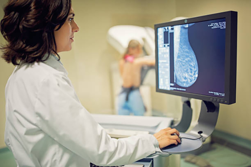 Doctor is working with mammography X-ray scanner in hospital
