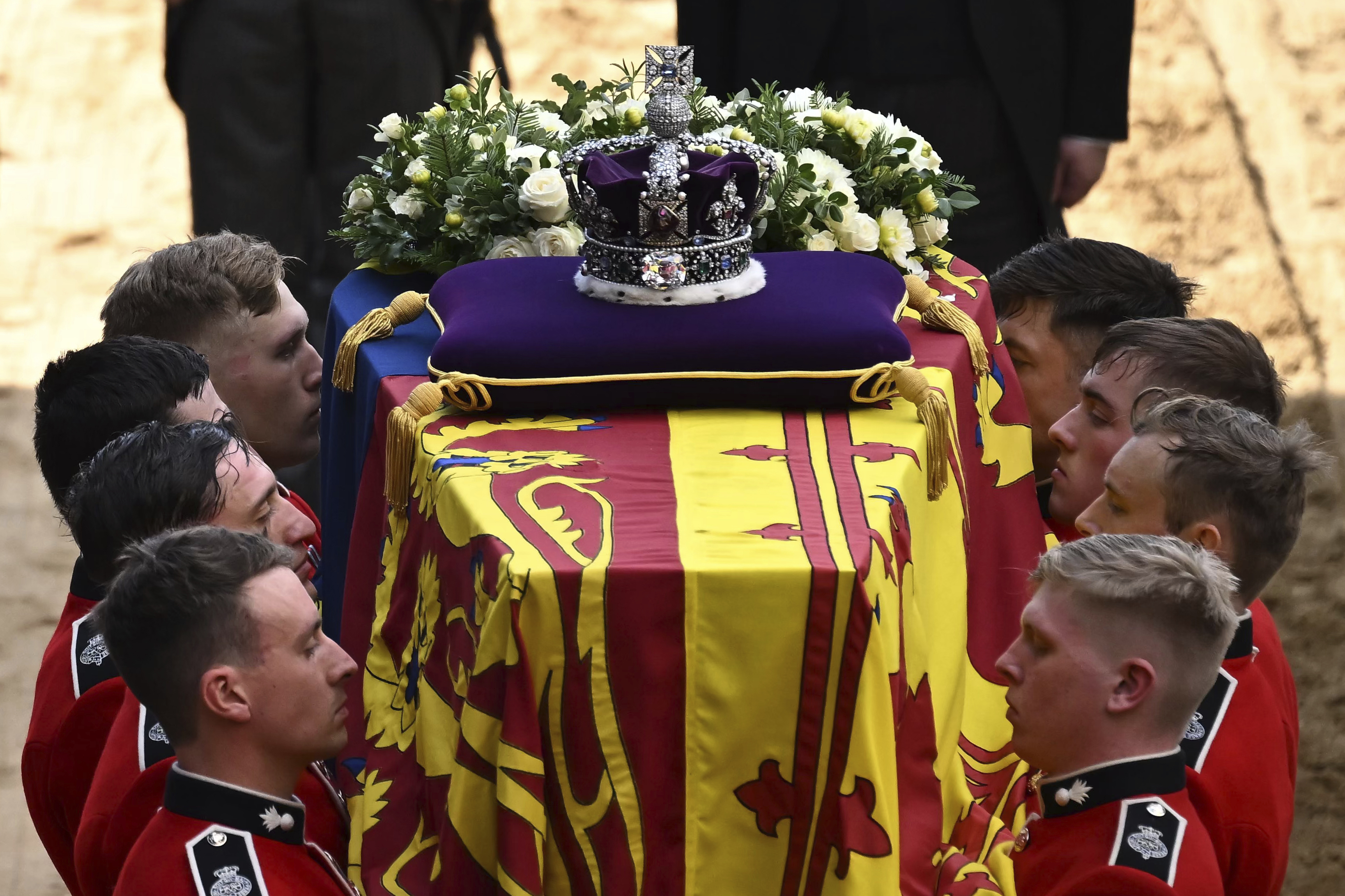Pallbearers from The Queen's Company, 1st Battalion Grenadier Guards prepare to carry the coffin of Queen Elizabeth II into Westminster Hall at the Palace of Westminster in London, Wednesday, Sept. 14, 2022. (Ben Stansall/Pool via P)